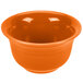 A Fiesta Tangerine china bouillon bowl with an orange background.