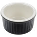 A black and white ceramic Tuxton fluted ramekin.