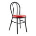 A black metal Lancaster Table & Seating Hairpin Chair with red vinyl seat.