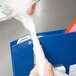A person using Shurtape red poly bag sealer tape to seal a plastic bag.
