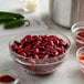 A bowl of Furmano's dark red kidney beans in brine on a counter.