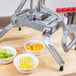 A Nemco vegetable slicer with bowls of lemon, orange, and lime slices.