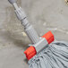 A Unger SmartColor gray string mop attached to a pole.
