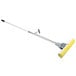 A Carlisle Flo-Pac foam sponge mop with a yellow handle and white foam sponge.