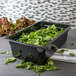 a container of spinach in a bowl
