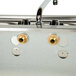 An Eagle Group stainless steel underbar sink with two brass faucets.