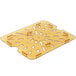 A yellow plastic Carlisle 1/2 size drain tray with holes.