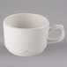 A close-up of a Libbey ivory porcelain coffee cup with a handle.