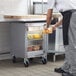 A man putting oranges in a Beverage-Air undercounter refrigerator.