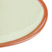A close up of a fern green Libbey terracotta plate.