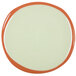 A white stoneware plate with an orange rim.