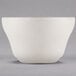 A Libbey St. Francis ivory porcelain bouillon bowl with a small handle on a gray surface.