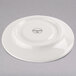 A white Libbey medium porcelain saucer.