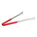 Two Vollrath tongs with red Kool-Touch handles and silver tips on a kitchen counter.