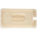 A Carlisle amber plastic container lid with a handle and spoon notch.