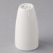 A Libbey ivory porcelain salt shaker on a gray surface.