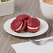 A Libbey ivory porcelain plate with red velvet cookies and a cup of coffee on it with a fork.