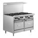 A large stainless steel Garland natural gas range with 8 burners and 2 space saver ovens.