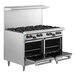 A large stainless steel Garland commercial gas range with two black knobs above each burner.