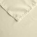 A close up of an ivory Intedge square cloth table cover.