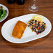 A CAC porcelain platter with salmon and salad on it.