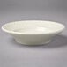 A close up of a Homer Laughlin ivory china bowl with a pattern on it.