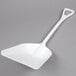 a white plastic shovel on a gray background
