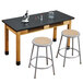 A black National Public Seating science lab table with built-in book compartments.