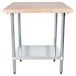 An Advance Tabco wood top work table with a galvanized metal base and undershelf.