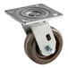 A Baxter Caster Assy with a metal wheel and metal plate.