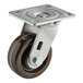 A Baxter caster assembly with a brown wheel and metal base.