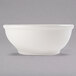 A white Libbey porcelain oatmeal bowl on a gray background.