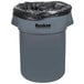 a grey garbage can with black plastic bag