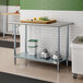 A kitchen with an Advance Tabco stainless steel work table with galvanized undershelf.