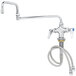 A T&S chrome deck-mounted pantry faucet with flex inlets and a hose.