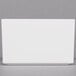 A white rectangular box with a gray border on a gray surface.