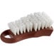 A brown and white Thunder Group cutting board brush with bristles.