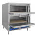 A stainless steel Bakers Pride countertop oven with a door open.