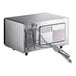 A stainless steel Amana commercial microwave with a cord.