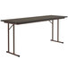 A rectangular Correll seminar table with metal legs and a walnut top.