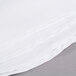 A stack of white Intedge poly/cotton blend table covers.