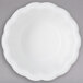 A white Carlisle ramekin with a scalloped edge.