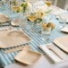 A table set with Bambu Veneerware bamboo forks, plates, and glasses.