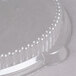 A clear plastic lid with a round top and small hole in it.