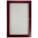 A red framed glass door with a maroon enclosed cherry finish.