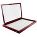 A rectangular cherry wood bulletin board cabinet with a white cover.