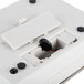 A white rectangular Edlund digital portion scale with black buttons and a black cord.