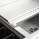 A close up of a stainless steel Eagle Group underbar cocktail and ice bin with a drain.