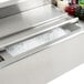 A stainless steel Eagle Group underbar ice bin with ice, drinks, and bottle holders.