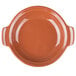 A large orange terracotta bowl with a handle.